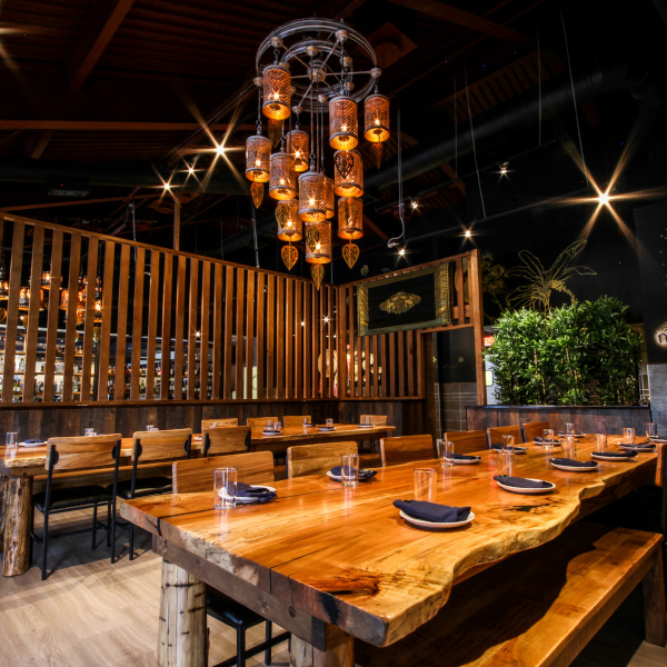 large wooden tables for more than 10 guests, oriental chandelier